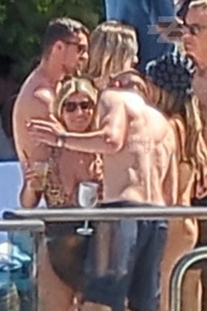Wrexham FC star Paul Mullin spotted shirtless and parties with girls while holding a giant Moet cup at pool party with his teammates in Las Vegas